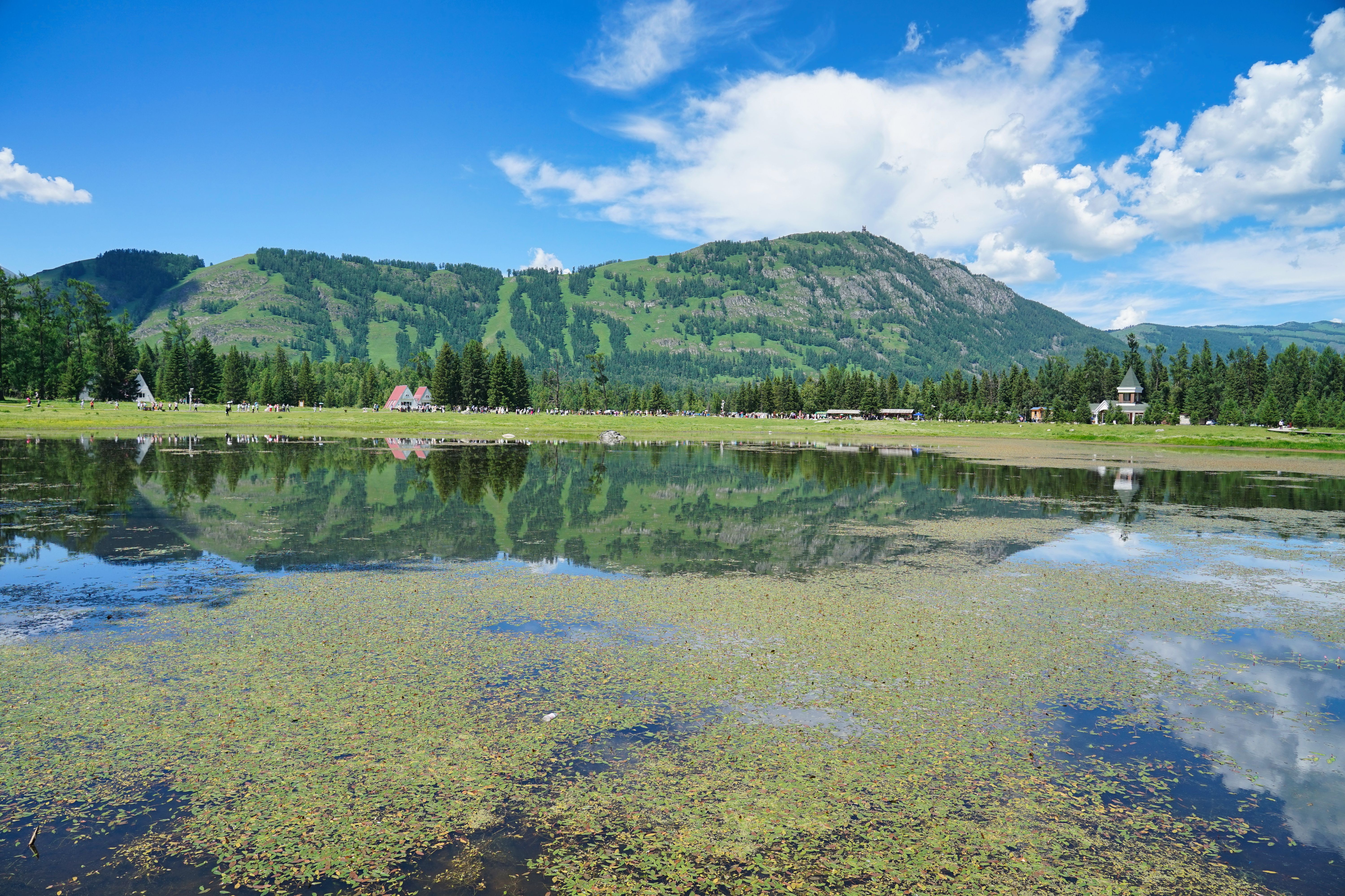 Sunlit mountain lake with clear reflection
